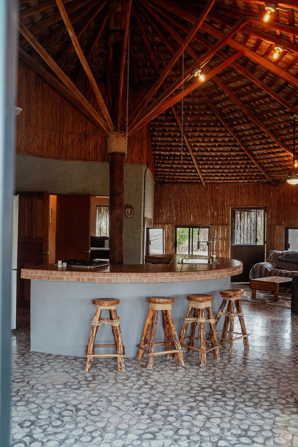 Kitchen island with barstools, palapa ceiling