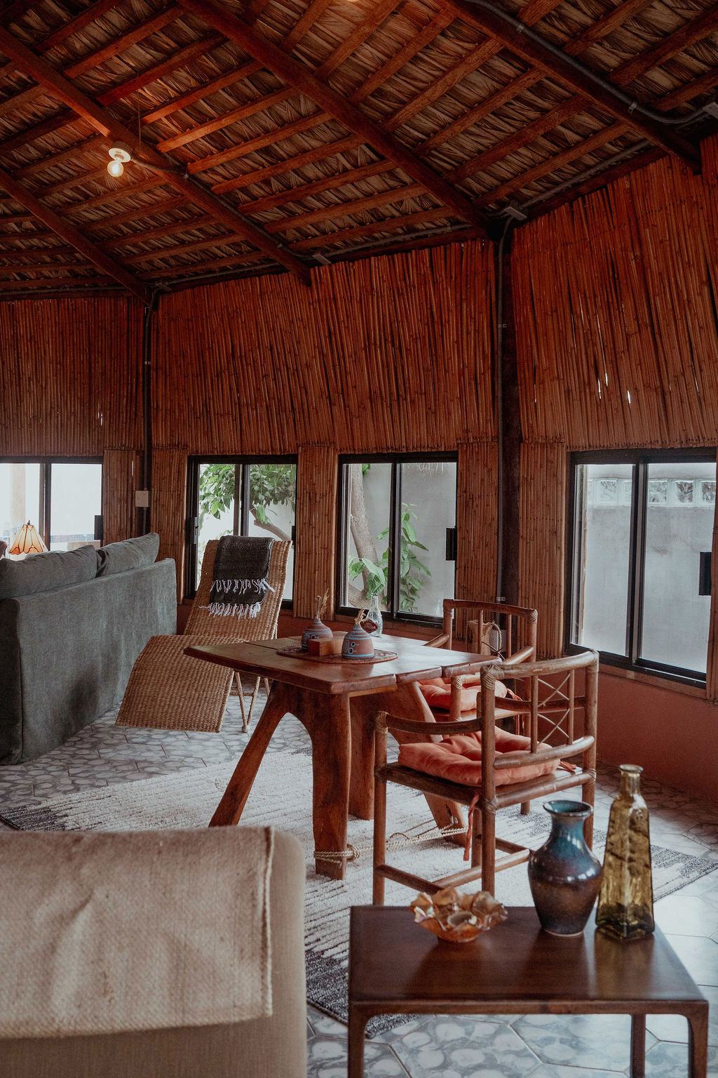 Dining table with rattan chairs and ceramics