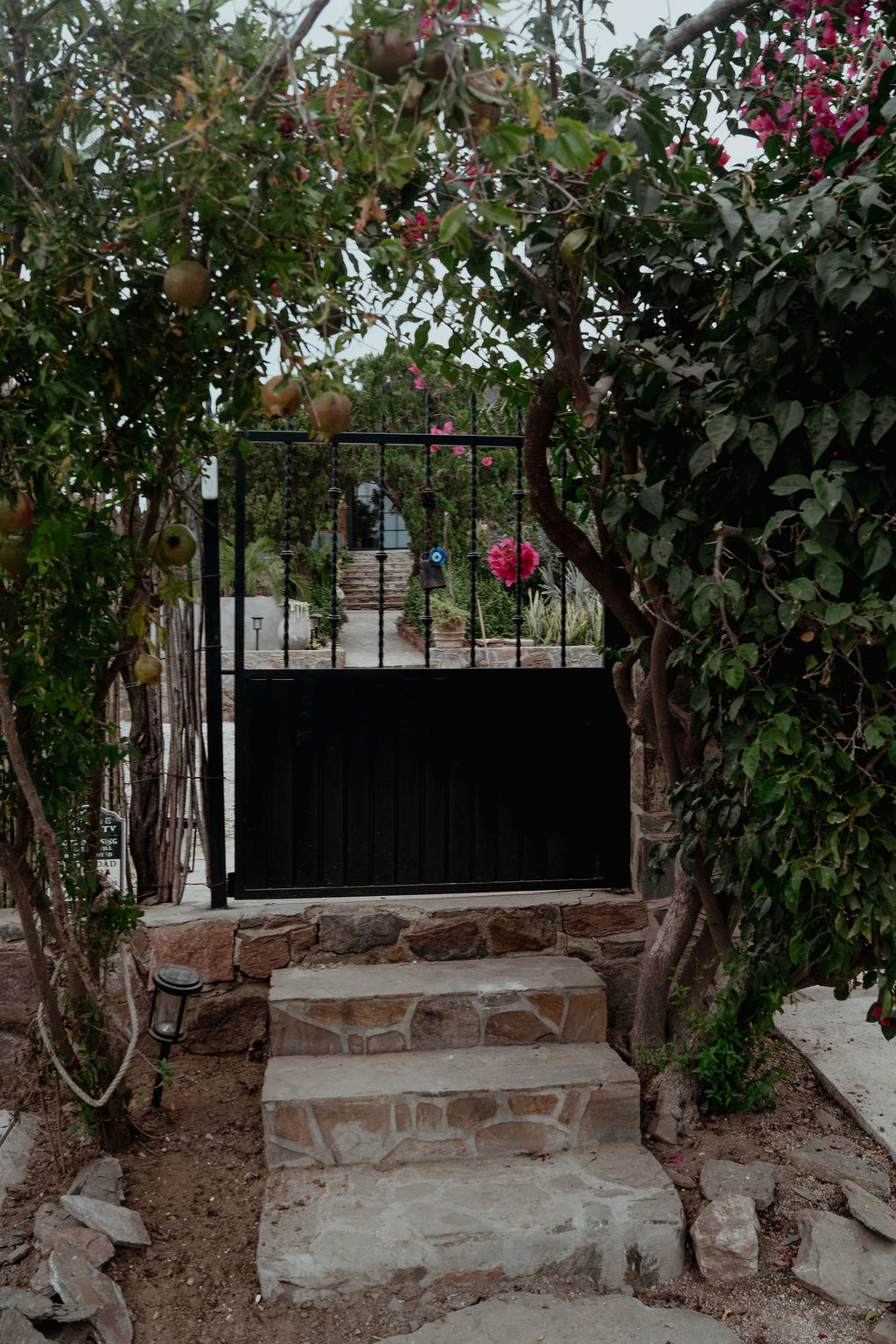 Pedestrian entrance gate with bougainvillea